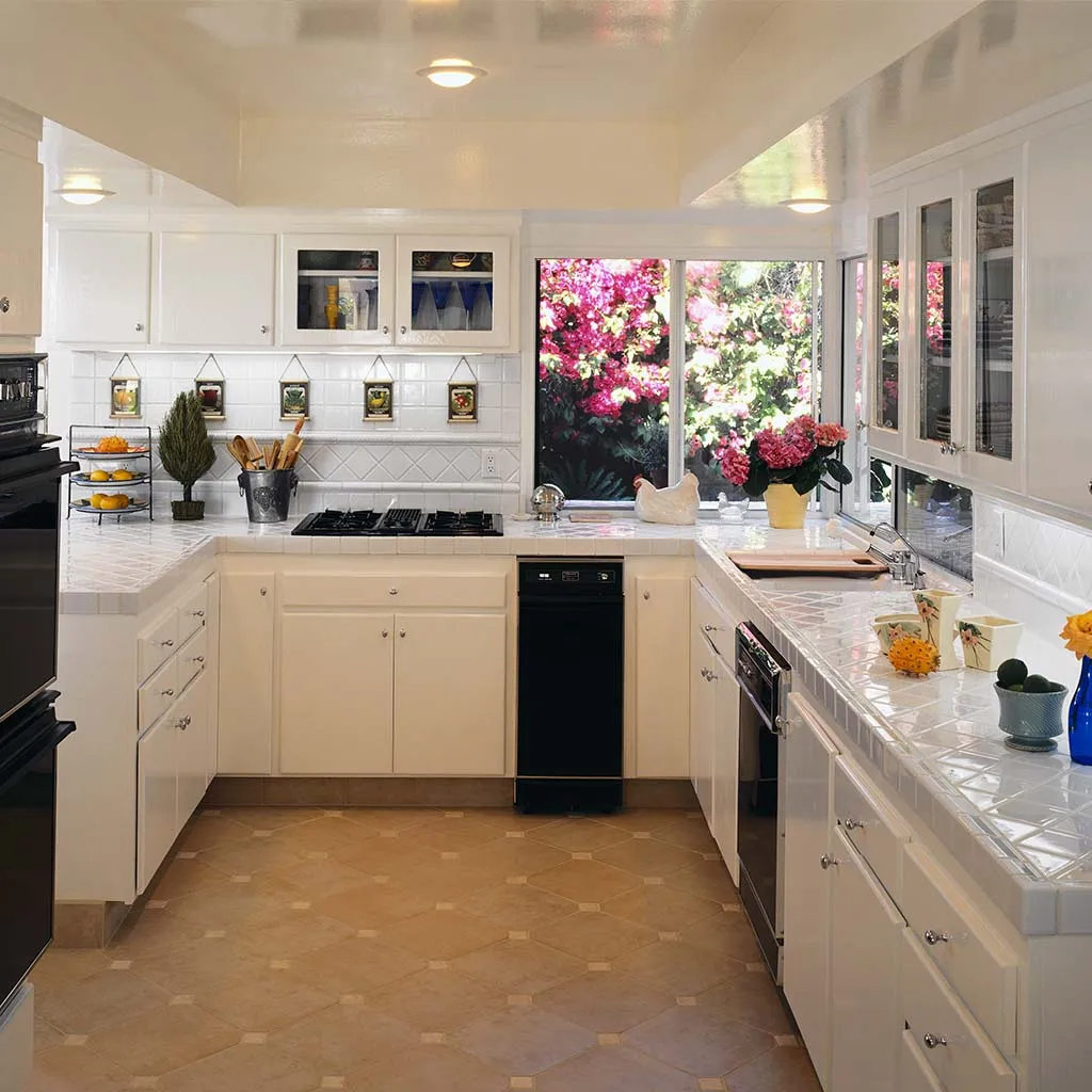 White kitchen with flowers on the counter